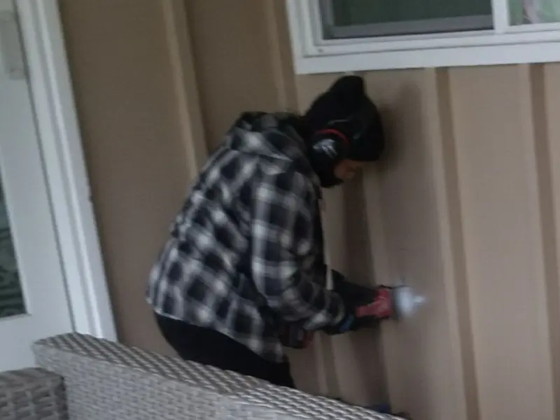 Professional electrician installing an exterior outlet in Bethalto